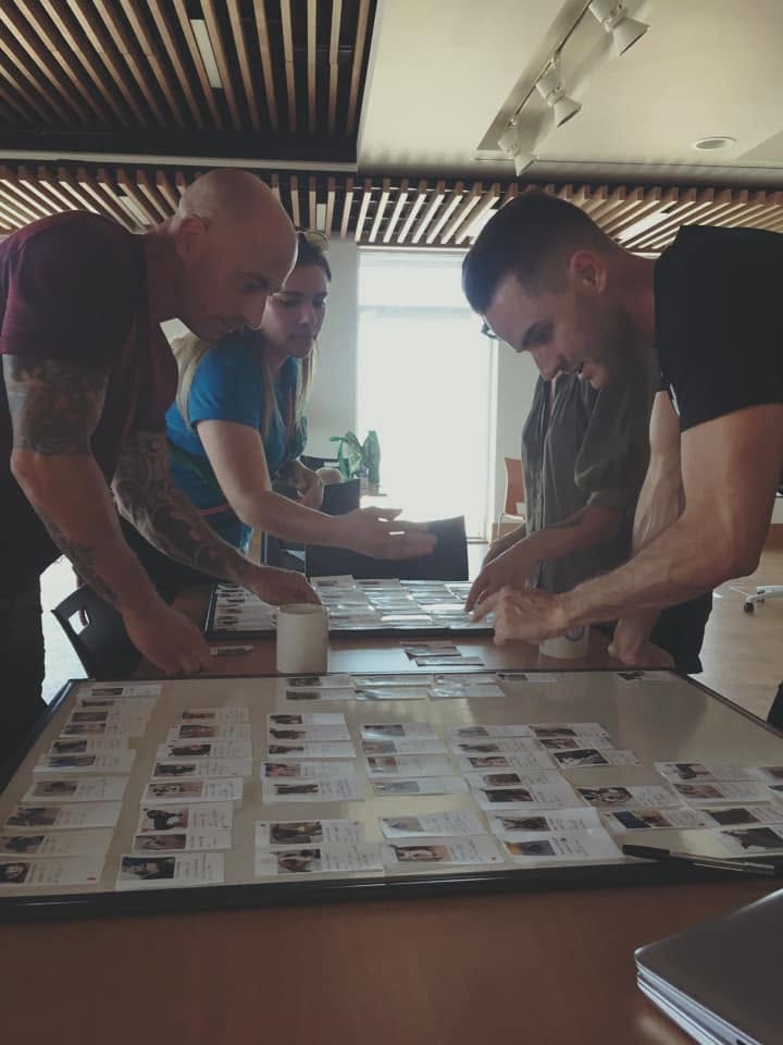 Nando Brown and Dean Nicholas planning a training session around a table of case notes