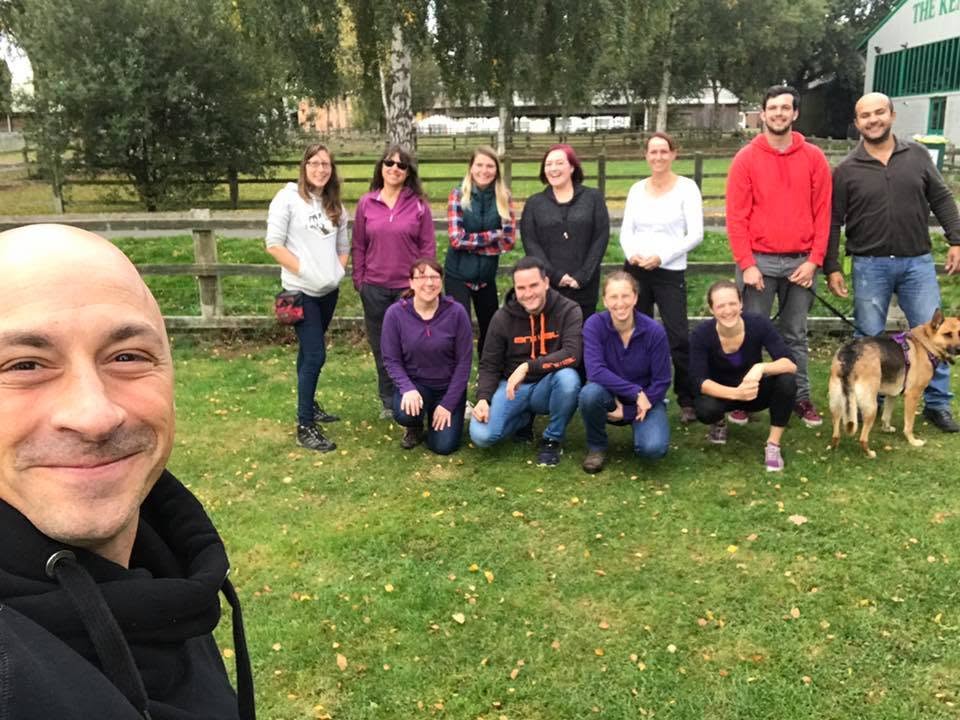 Nando Brown with a course group and a dog on a training field